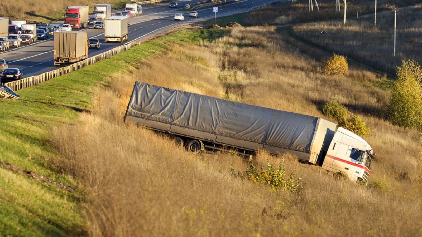 The truck lies in a ditch after the road accident