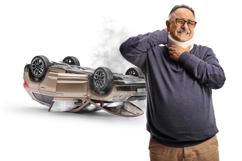 Mature man in pain wearing a neck collar, car accident injury