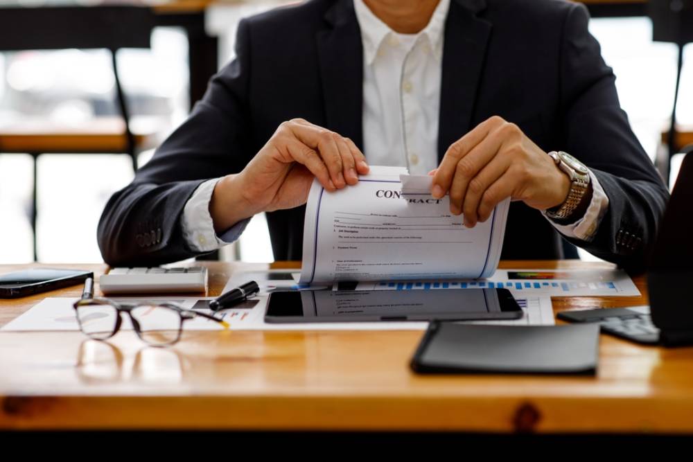 Businessman tears contract in the office,