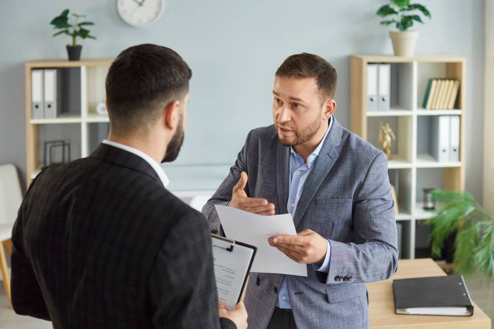 Dissatisfied business people colleagues disputing having disagreement at workplace